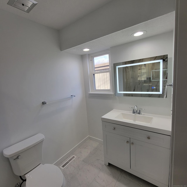 bathroom with toilet and vanity