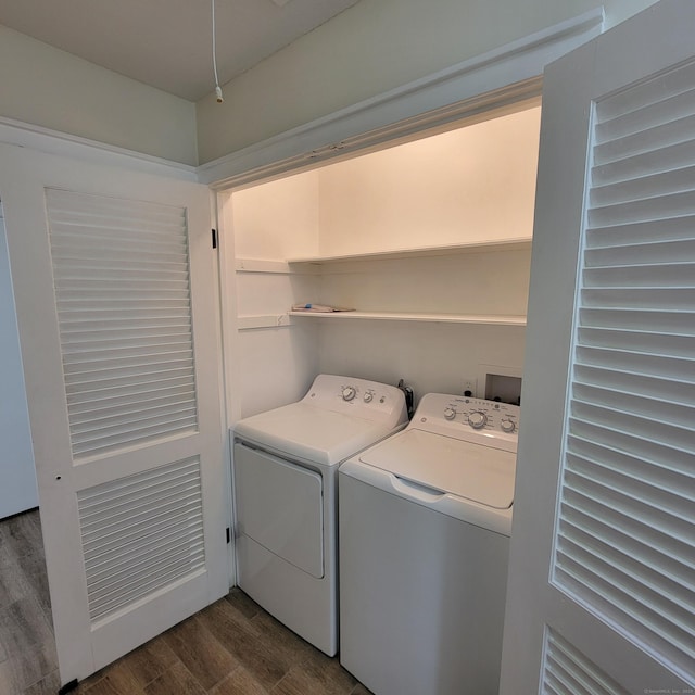 washroom with dark hardwood / wood-style flooring and independent washer and dryer