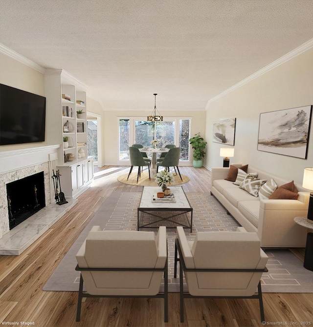 living room with a premium fireplace, crown molding, a textured ceiling, and hardwood / wood-style floors