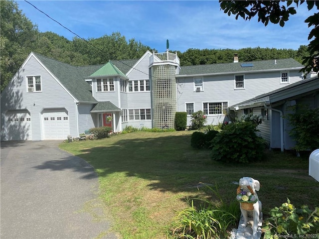 front of property with a front lawn and a garage