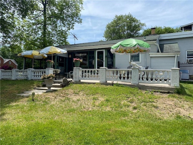 back of house featuring a lawn