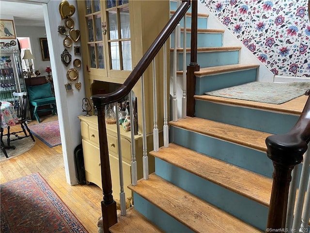 staircase with hardwood / wood-style floors