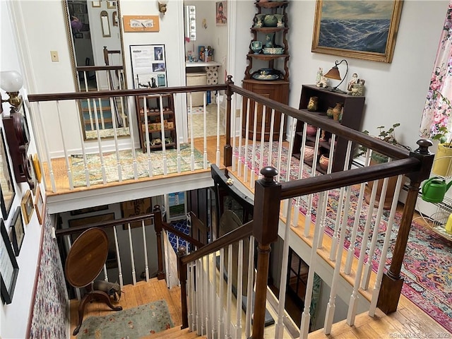 staircase with hardwood / wood-style flooring