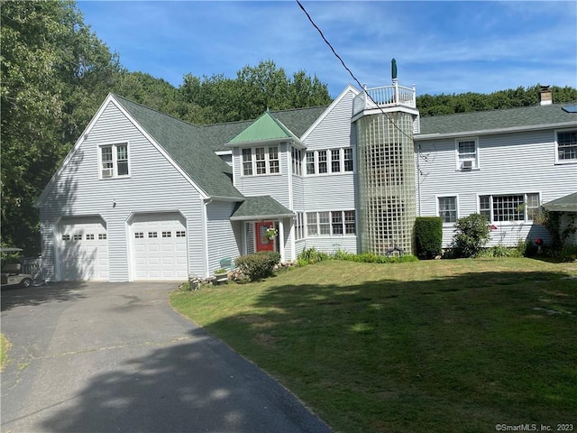 view of front facade with a garage and a front lawn