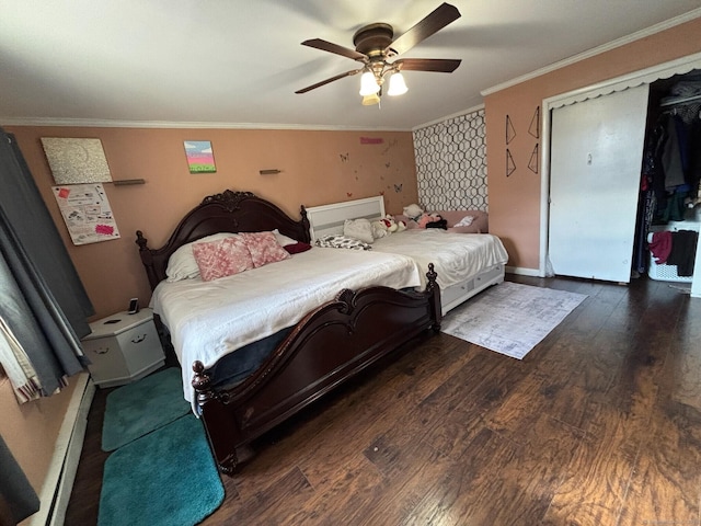 bedroom featuring ceiling fan, crown molding, dark hardwood / wood-style floors, and a baseboard heating unit