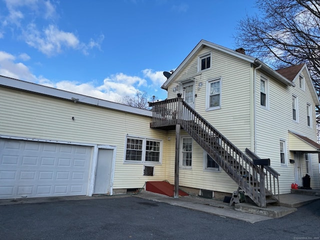 back of property featuring a garage