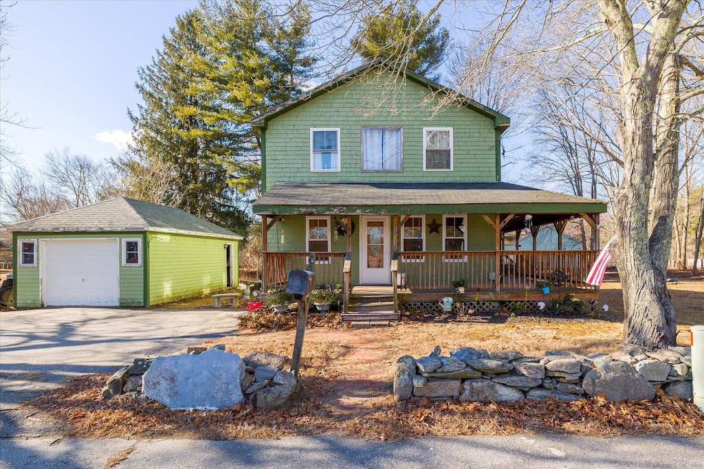 view of front of house with an outbuilding, covered porch, and a garage