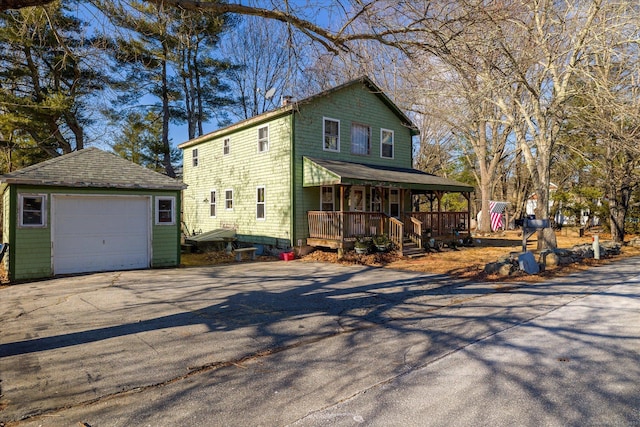 view of front of home with an outdoor structure, a porch, and a garage