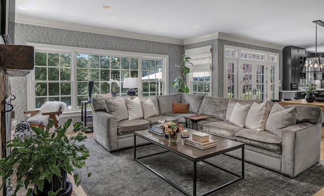 living room featuring a chandelier and ornamental molding