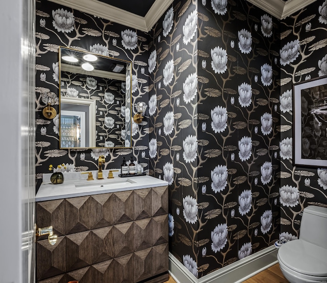 bathroom with hardwood / wood-style floors, vanity, toilet, and crown molding