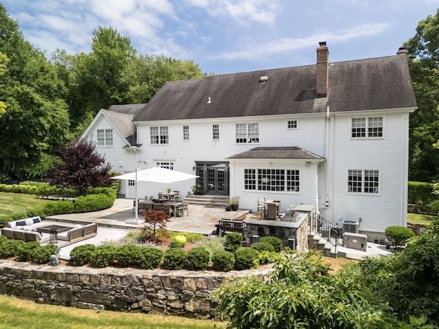 rear view of property with a patio and central AC unit