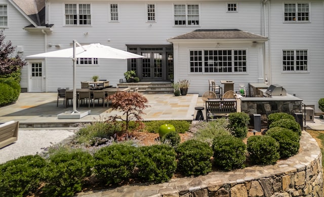 back of property featuring french doors and a patio area