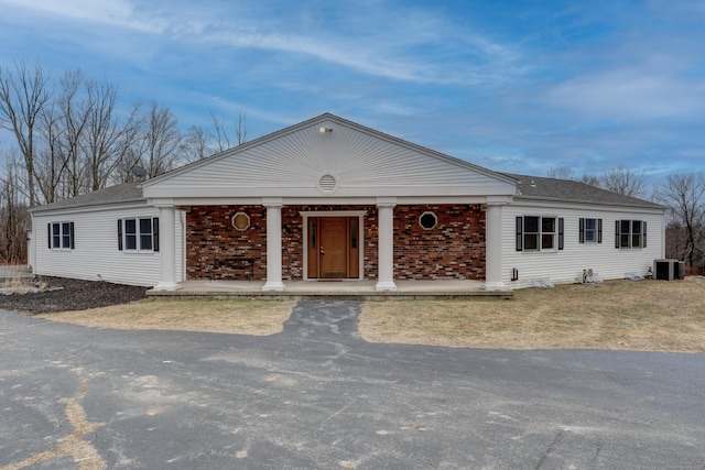 ranch-style house with covered porch and central air condition unit