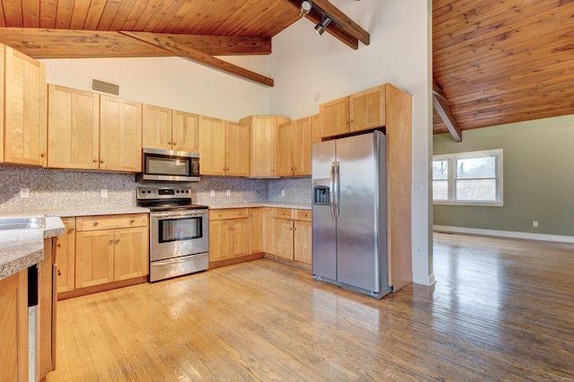 kitchen with beam ceiling, decorative backsplash, high vaulted ceiling, and stainless steel appliances