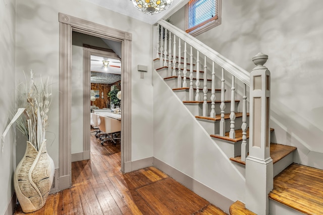 stairs featuring wood-type flooring