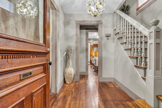 foyer entrance featuring hardwood / wood-style floors and a textured ceiling