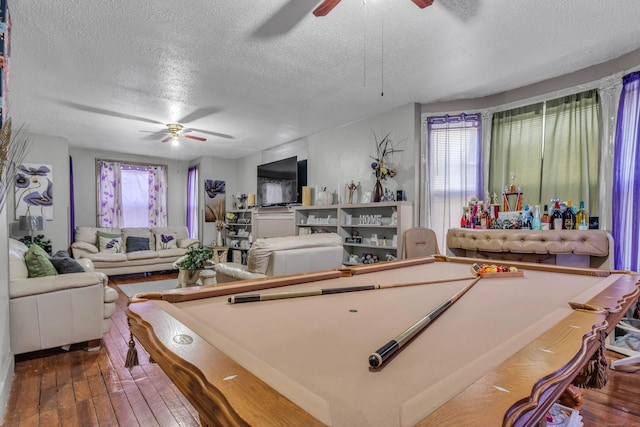 rec room featuring hardwood / wood-style floors, ceiling fan, a textured ceiling, and pool table