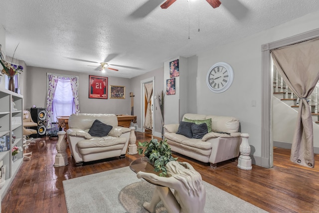 living room featuring dark hardwood / wood-style flooring and a textured ceiling