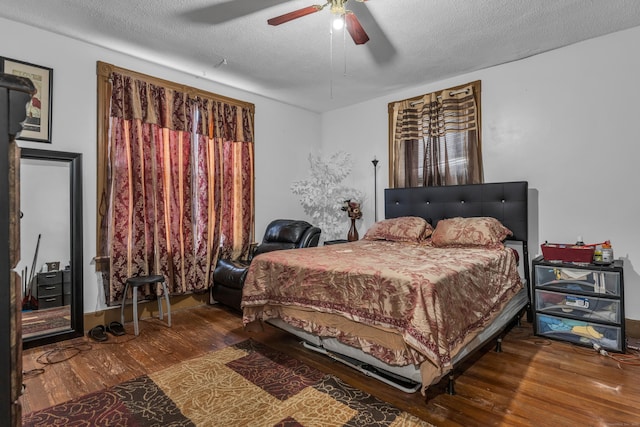 bedroom featuring wood-type flooring, a textured ceiling, and ceiling fan