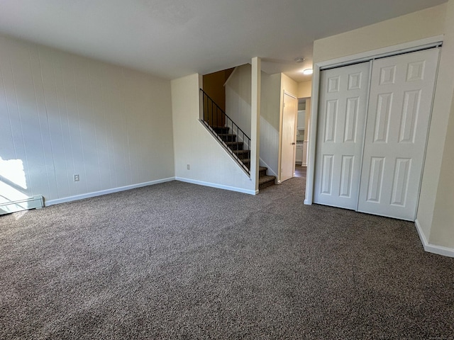 unfurnished living room featuring dark colored carpet