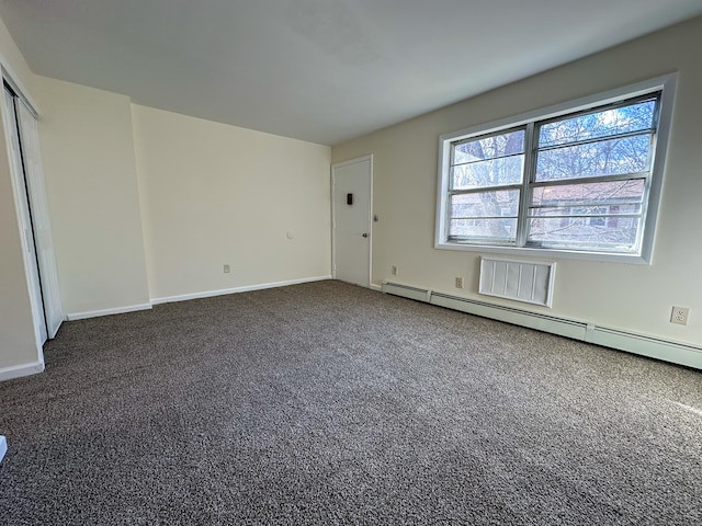 interior space featuring a baseboard radiator and dark carpet