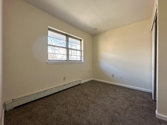 unfurnished bedroom with a baseboard radiator, dark carpet, and a closet