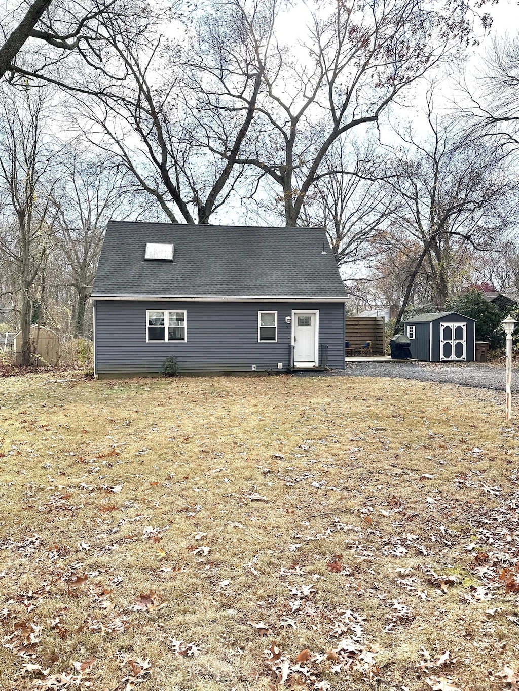 exterior space featuring a storage shed and a front lawn