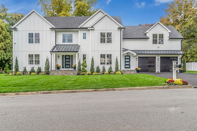 modern farmhouse featuring aphalt driveway, roof with shingles, an attached garage, a standing seam roof, and board and batten siding