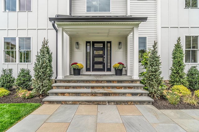 doorway to property with covered porch and board and batten siding