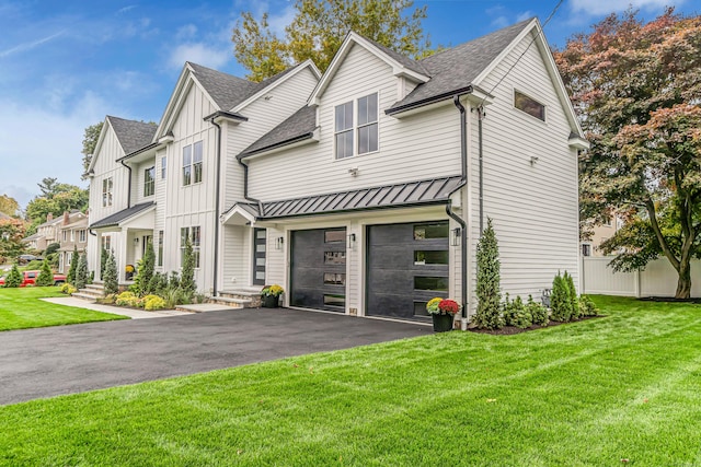 view of front of house featuring a front yard and a garage