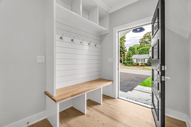 mudroom featuring light wood-style floors and baseboards