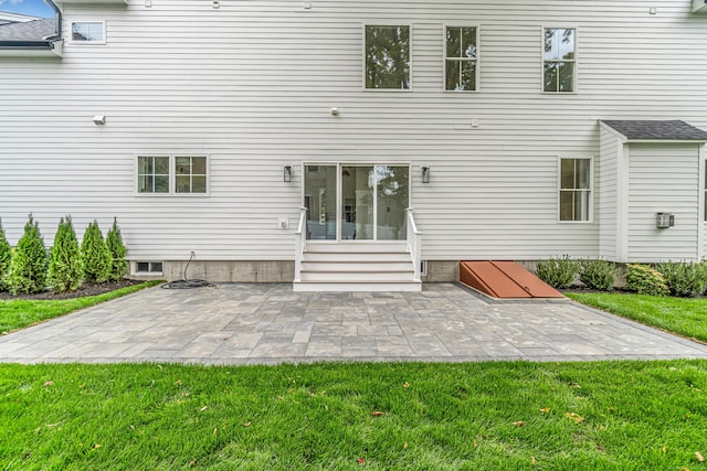 rear view of property featuring a patio area and a yard