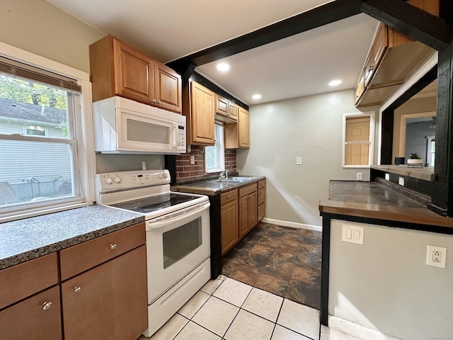 kitchen with backsplash, sink, and white appliances