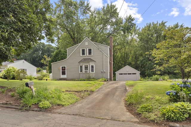 view of front facade with an outbuilding, a front lawn, and a garage