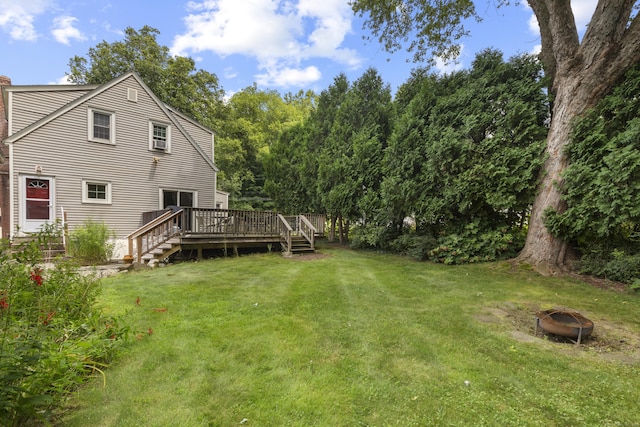 view of yard featuring a fire pit and a wooden deck