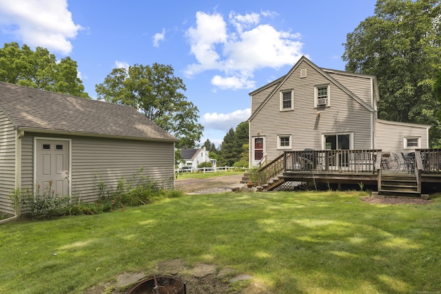 back of house featuring a deck and a yard