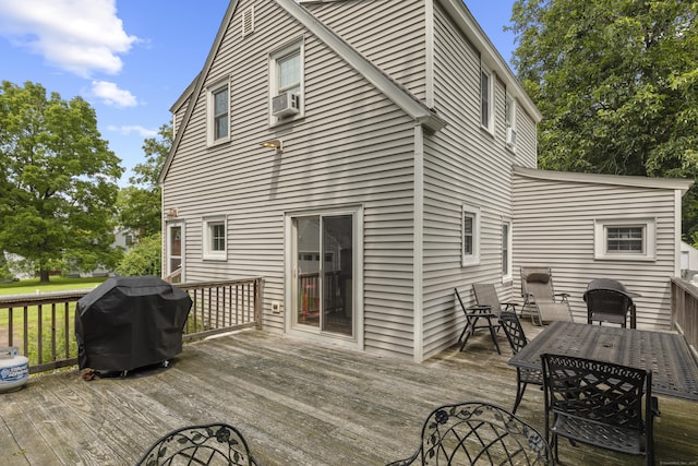 wooden deck featuring cooling unit and grilling area