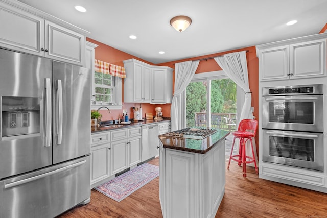 kitchen with white cabinets, appliances with stainless steel finishes, and sink