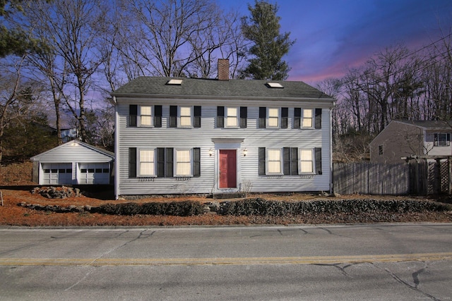 colonial house with an outbuilding and a garage