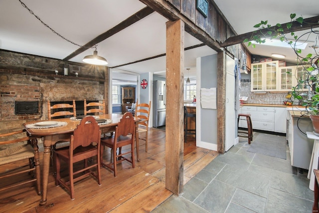 dining room with a healthy amount of sunlight and beam ceiling