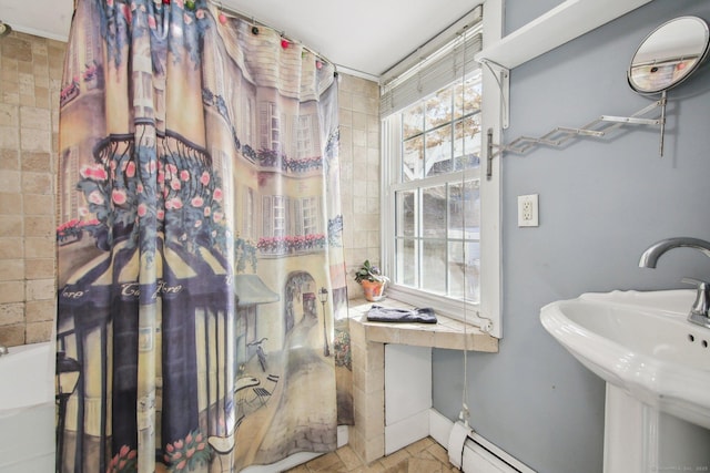 bathroom with sink, plenty of natural light, and baseboard heating