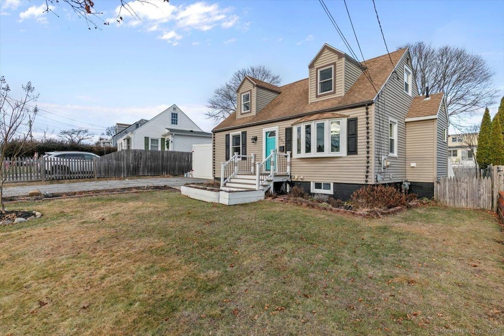 cape cod house with a front lawn