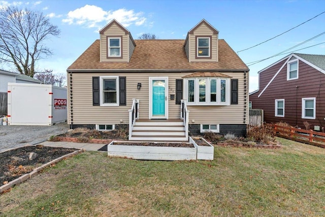 cape cod home with a front yard