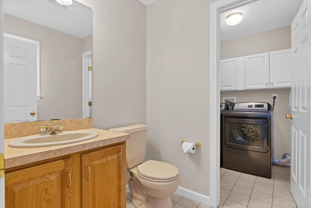 bathroom featuring washer / clothes dryer, vanity, tile patterned floors, and toilet