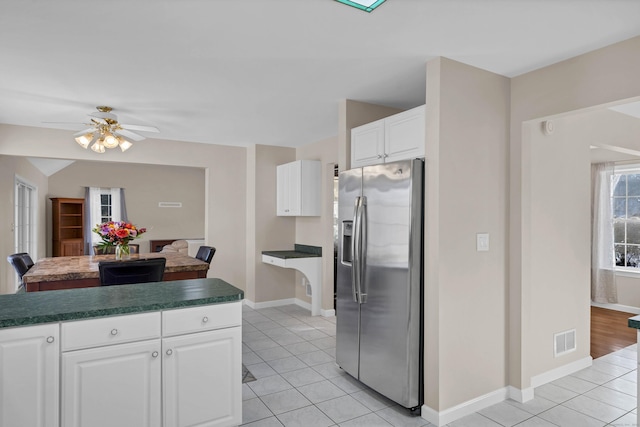 kitchen with white cabinetry, light tile patterned floors, ceiling fan, and stainless steel refrigerator with ice dispenser