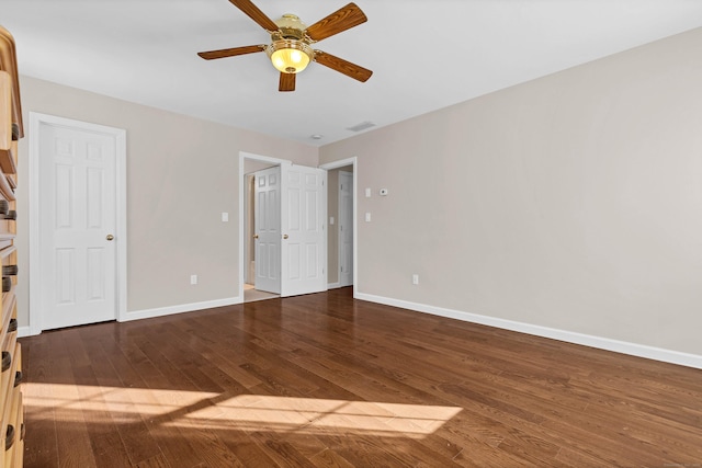 unfurnished room with ceiling fan and dark hardwood / wood-style flooring