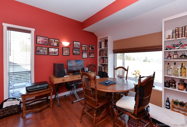 dining space with built in features and hardwood / wood-style floors