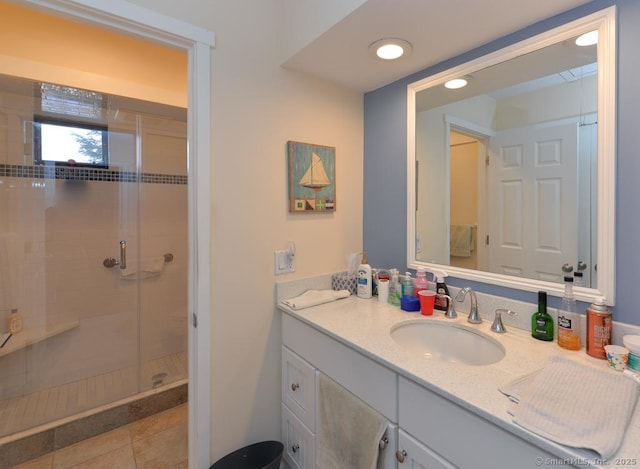 bathroom with tile patterned flooring, vanity, and a shower with shower door