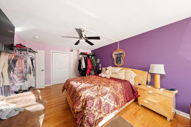 bedroom featuring ceiling fan, light wood-type flooring, and a closet