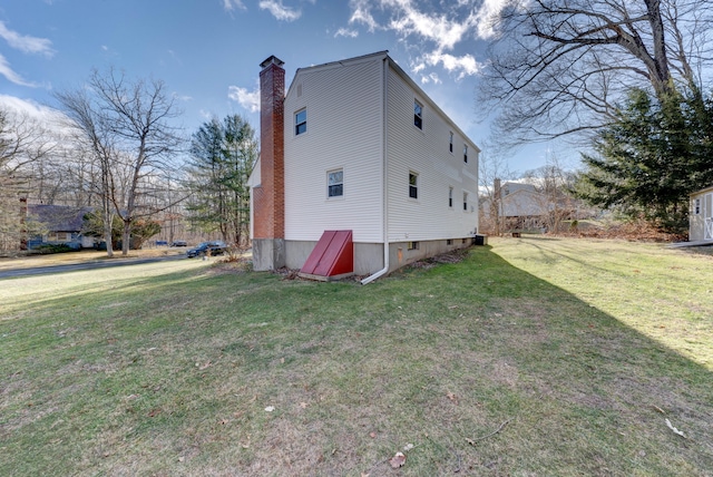 view of property exterior featuring a lawn